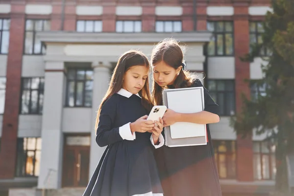 Bücher Halten Zwei Schülerinnen Stehen Gemeinsam Der Nähe Eines Schulgebäudes — Stockfoto
