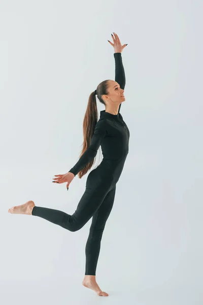 Black Sportive Clothes Young Woman Doing Gymnastics Indoors — Stock Photo, Image