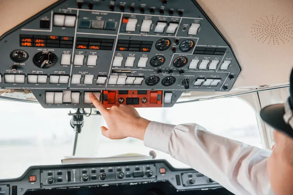 Close up view. Pilot on the work in the passenger airplane. Preparing for takeoff.