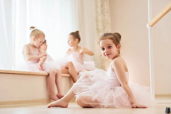 女の子は床に座っている ダンスの練習でパフォーマンスの準備をしている小さなバレリーナ — ストック写真