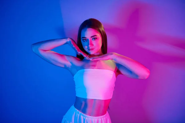 Beyaz Elbiseler Stüdyoda Neon Işığıyla Duran Şık Bir Genç Kadın — Stok fotoğraf