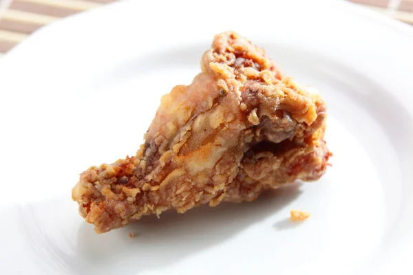 Roasted chicken leg on white dish — Stock Photo, Image