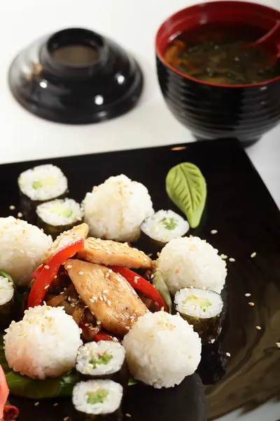 Fresh and tasty sushi in black dish — Stock Photo, Image