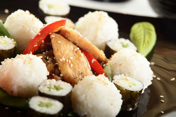 Fresh and tasty sushi in black dish — Stock Photo, Image