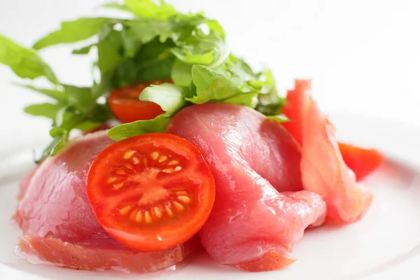 Sliced peaces of meat with tomato — Stock Photo, Image