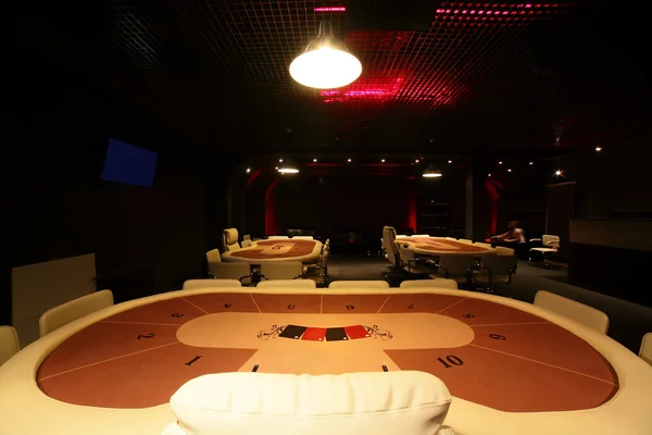 Dark and fashionable casino with tables — Stock Photo, Image