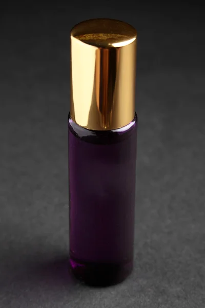 Little parfume bottle on black background — Stock Photo, Image