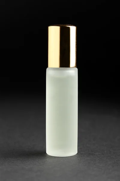 Little parfume bottle on black background — Stock Photo, Image