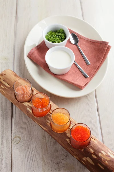 Red caviar assorti with herbs and sour cream — Stock Photo, Image