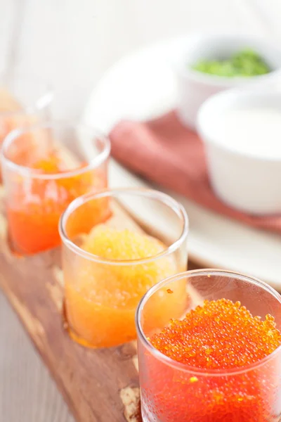 Red caviar assorti with herbs and sour cream — Stock Photo, Image