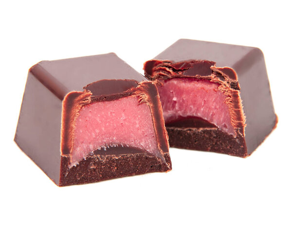 Chocolate candies sweets with pink strawberry filling isolated on the white