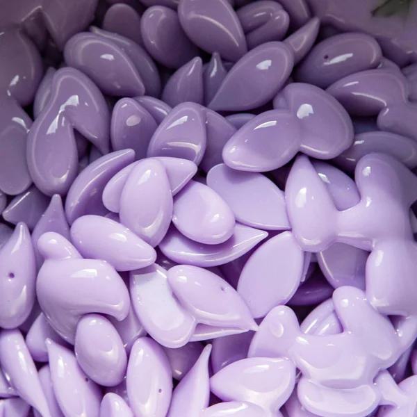 Violet melted wax drops for beauty depilation cosmetic