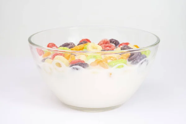 Delicious and nutritious fruit cereal loops multicolored flavorful on white background, healthy and funny addition to kids breakfast