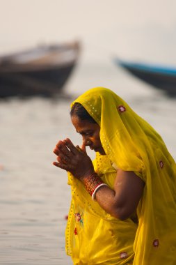 Hindu Woman Bowing Praying Ganges River Varanasi clipart
