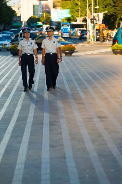 Young Korean Men Police Patrol Seoul Downtown clipart