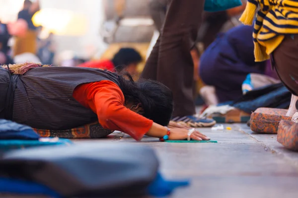 Tibetské pilgrim prostrating rovné zemi jokhang — Stock fotografie