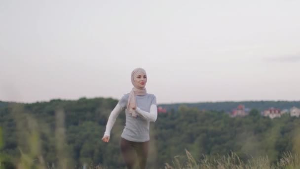 Happy arabian woman in hijab in activewear running at summer park . — Stok Video