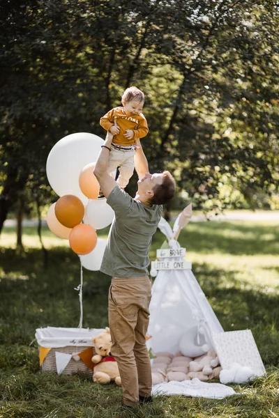 Pai se divertindo com pouco filho bonito entre a natureza verde — Fotografia de Stock