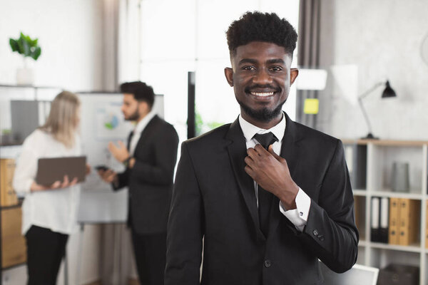 African american man smiling and looking at camera at office