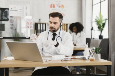 Hasta ile çevrimiçi randevusu olan kulaklıklı bir doktor.
