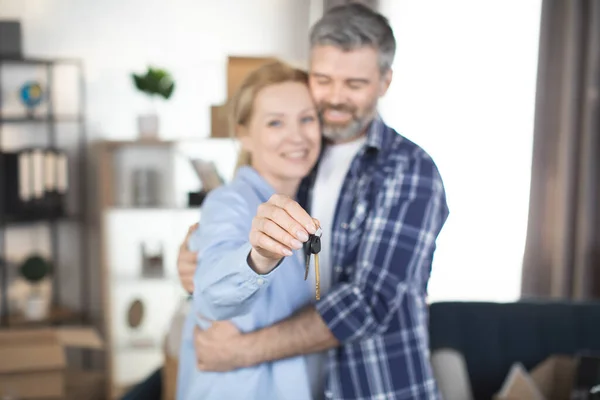 Primer plano de la pareja caucásica de mediana edad mostrando las llaves de la nueva casa — Foto de Stock