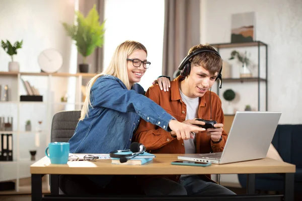 Happy young people enjoying video game, using laptop and joystick — Foto de Stock