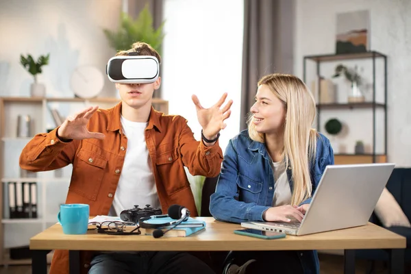 Excited young people using VR glasses for having fun at home — Photo