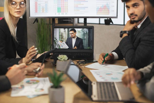 İş Adamları Grubu, modern ofiste toplantı salonunda video konferansı düzenliyor.