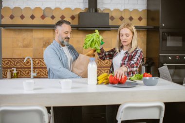 Olgun beyaz bir aile, mutfaktan alışveriş yapıyor.