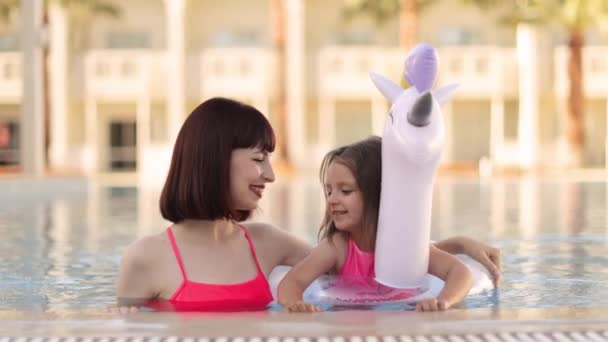 Χαμογελαστή οικογένεια στην πισίνα, ευτυχισμένη μητέρα και κόρη διασκεδάζουν. — Αρχείο Βίντεο
