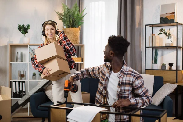 Loving multiracial couple having fun while renovating house