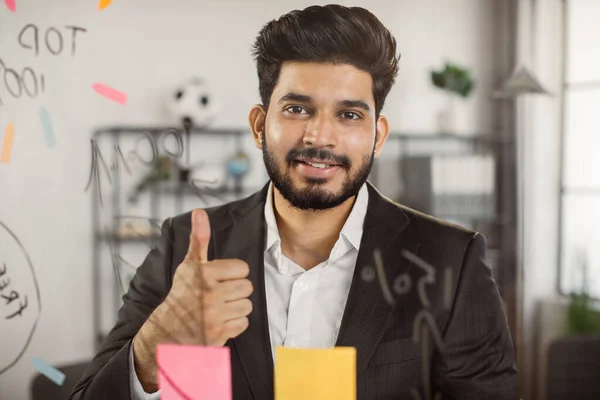 Portrait of indian office manager showing thumb up sign