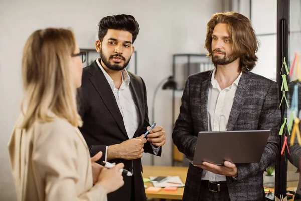 Concentrated man presenting new ideas to employees in office