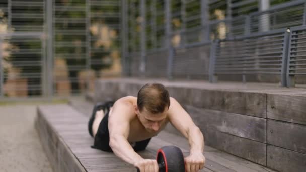 Athletic Sporty Caucasian Shirtless Man Doing Exercise Abs Roller Wheel — Stock Video