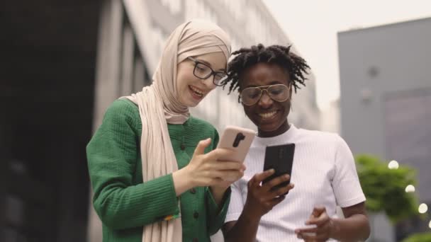 Moslim Zakenvrouw Groene Jas Toont Iets Smartphone Aan Haar Vrouwelijke — Stockvideo