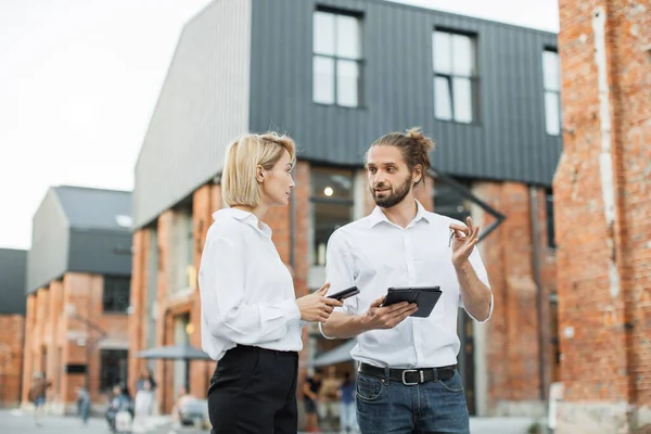 Happy smiling business woman taking key of future new apartment. Professional real estate agent wearing white shirt holding in hand and giving keys to young buyer. Mortgage, Property For Sale Concept