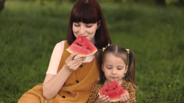 Young Mother Resting Her Daughter Park Holding Watermelon Hands While — Stockvideo