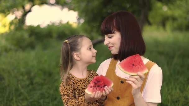 Young Mother Resting Her Daughter Park Touch Noses Holding Watermelon — Stockvideo