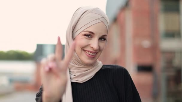 Young Muslim Woman Beige Hijab Dark Clothes Looking Camera While — Vídeos de Stock
