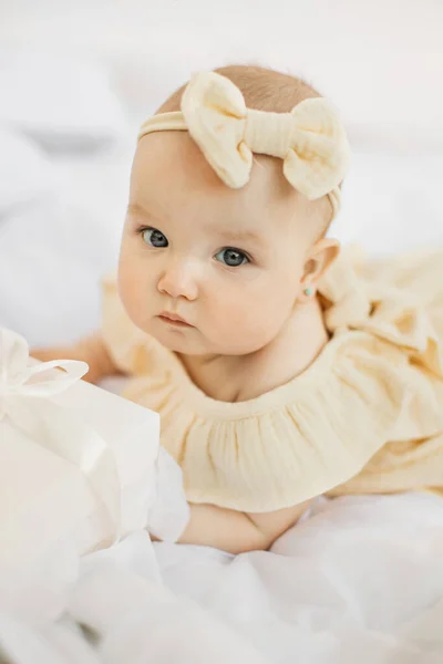 Happy Little Girl Infant Yellow Dress Bow Her Head Bed — Fotografia de Stock