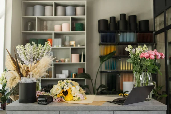 Loft modern interior of flower shop . Floral design studio, decorations and compositions, gifts. Flower delivery and sale of indoor plants in pots, showcase.