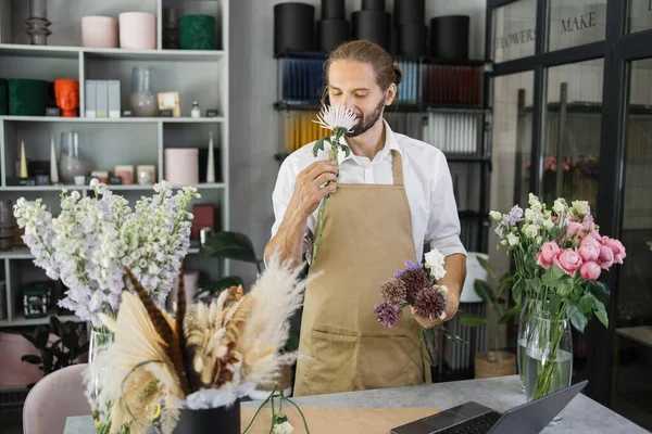 Handsome Guy Florist Smells Beautiful Flower Flower Shop Attractive Bearded —  Fotos de Stock