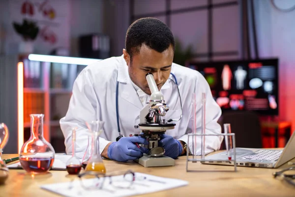 Young African American Male Researcher Looking Microscope Analyze Science Forensics — Zdjęcie stockowe