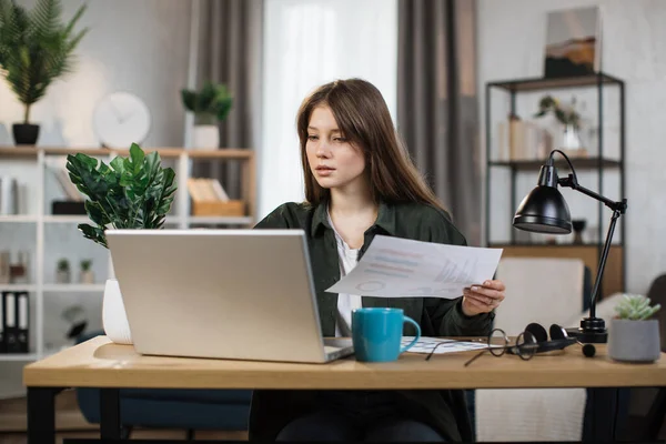 Likable Young Caucasian Woman Sitting Desk Laptop Holding Papers Pleasant —  Fotos de Stock