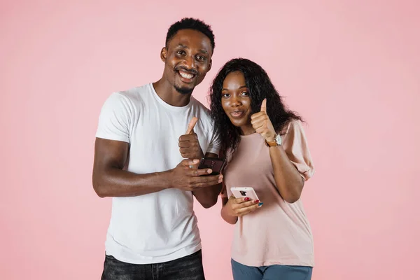 Cheerful African American Millennial Couple Browsing Cell Phones Networking Chatting — Zdjęcie stockowe