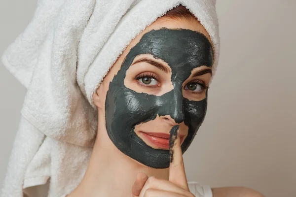 Attractive Young Lady Smiling Looking Camera Black Clay Mask Her — Stok fotoğraf