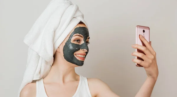 Attractive Young Woman Black Cosmetic Mask Her Face Holding Smart — Stock Photo, Image