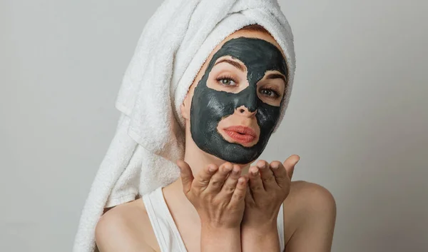 Portrait Smiling Young Woman Cosmetic Mask Face Blowing Air Kiss — Fotografia de Stock