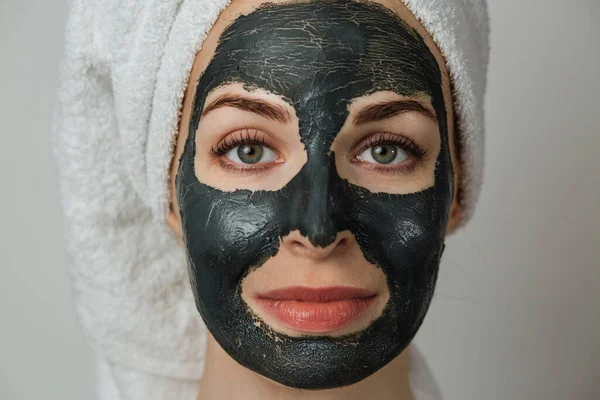 Portrait Young Caucasian Woman Towel Black Clay Cosmetic Mask Her — Stok Foto