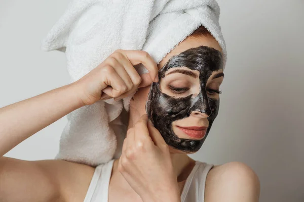 Beautiful Young Woman Removing Black Cosmetic Mask Face White Towel — Fotografia de Stock